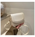 Close-up of cream textured leather mini crossbody bag with gold hardware and strap - No Pendant / White