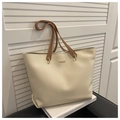 Detail of minimalist cream tote bag with brown straps and golden rectangular buckle - White