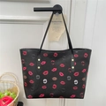 Black tote bag with red and pink lip print patterns and slender shoulder straps - Black