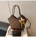 Close-up of brown patchwork bucket bag with quilted patterns and cute bear charm - Coffee with Pendant