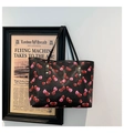 Detail of cherry pattern tote bag with gold rivets and black leather straps for women - Black