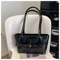 Detail of glossy black leather tote bag featuring a gold buckle and elegant logo branding - Black