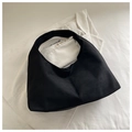Detail of minimalist black hobo bag with seamless handle and soft textured fabric - Black