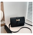 Detail of black woven texture handbag with signature gold H-clasp and leather strap - Black