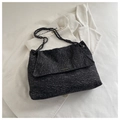 Macro detail of black snowflake texture fabric and metal chain strap on tote bag - Black