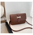 Detailed close-up of brown woven PU leather texture with gold metal buckle on crossbody bag - Brown