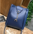 Dark blue mini bucket crossbody bag featuring a silver deer charm on marble surface - Dark Blue