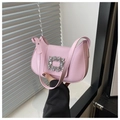 Detailed close-up of pink crescent underarm bag with sparkling oversized crystal buckle - Pink