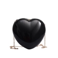 Glossy black heart shaped crossbody bag with elegant gold chain strap on white background - Black