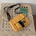 Yellow canvas messenger bag with adjustable strap and fashion label on a table - Yellow (No Pendant)