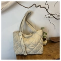 Macro detail of beige quilted tote bag with lattice stitching and EARE letter ribbon strap - Off White