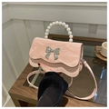 Detail of pink pleated faux leather bag with large silver bow and pearl bead handle - Pink