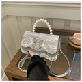 Detail of silver pleated handbag with faux pearl handle and metal bow clasp - Gray