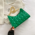 Vibrant green quilted shoulder bag with chunky gold chain strap on tweed background - Green