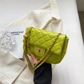 Quilted lime green chain crossbody bag with golden clasp and decorative ball charm - Kiwi Green