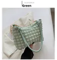 Detail of mint green popcorn texture fabric and gold hardware on a stylish shoulder bag - Green