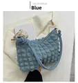 Close-up of blue bubble textured hobo bag with zip closure on stylish blazer - Blue