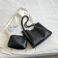 Minimalist black leather tote bag set with matching zippered clutch on white backdrop - Black