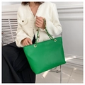 Detail of green tote bag with snake skin pattern texture and golden chain strap - Green