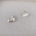 Textured silver heart earrings with hammered surface on minimalist linen background - Silver