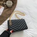 Elegant black quilted crossbody bag with gold chain strap and V-shaped stitching detail - Black