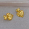 Textured gold double heart earrings with elegant vertical ribbing on a neutral fabric - Gold
