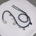 Handmade woven rope necklace with shell motifs, pearls, and stones in a ceramic dish - Shell Pleated Necklace
