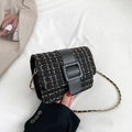 Classic black and gold tweed chain crossbody bag with elegant buckle on white fabric - Black