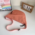 Pinkish orange nylon crescent bag with adjustable strap and casual dumpling style - Orange