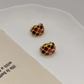 Retro gold-plated hoop earrings with colorful enamel geometric patterns in a white dish - Gold