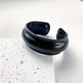 Close-up of wide black genuine leather cuff bracelet with fine stitching on stone - Narrow / Black
