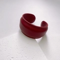 Detail view of deep red wide leather bracelet with fine stitching and natural texture - Width / Red