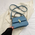 Minimalist haze blue trapezoid crossbody bag with elegant gold S-shaped twist lock - Blue