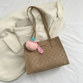 Brown checkered quilted tote bag with peach charm on a stylish beige blazer background - Khaki