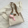 Beige woven texture tote bag with brown leather straps and peach plush keychain charm - Brown