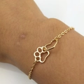 Eco-friendly gold alloy bracelet featuring hollow heart and paw print charms on wrist - Gold