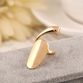 Detailed view of golden metallic nail ring with mirror finish on grey velvet background - Gold