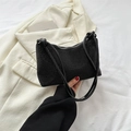 Sparkling black rhinestone handbag with circular top handle on white blazer - Black