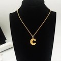 Detail view of 18K gold plated capital letter C pendant necklace on black velvet display - Uppercase Letter C