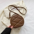 Brown quilted round crossbody bag with geometric texture and gold zipper detail - Brown
