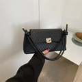 Elegant black quilted shoulder bag with woven texture and gold wave clasp closure - Black