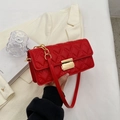 Red quilted crossbody bag with gold rectangular clasp and chain strap in a stylish setup - Red