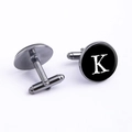 Macro view showing the front 'K' letter design and bullet back structure of gunmetal cufflinks - Letter K