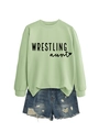Flat lay of light green crewneck sweatshirt with Wrestling Aunt print and ripped denim shorts - Olive Green Sweatshirt (Black Font)