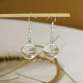 Detail of handmade glass globe earrings featuring real dandelion seeds inside - Dandelion Seed Glass Ball Style