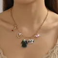 Close-up of a gold stainless steel necklace with ocean-themed pendants on model neck - Camera Academy Style