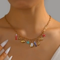 Gold ocean theme necklace with colorful sea charms like starfish and shells on a model - Stainless Steel Ocean Elements