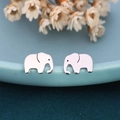 Polished silver elephant stud earrings displayed on a light blue ceramic bowl edge - Elephant / Silver