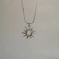 Detail of sunburst pendant with hollow center on sleek silver-tone snake chain - Titanium Steel Sun Pendant with Snake Chain