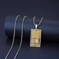 Macro view of silver stainless steel tarot pendant featuring vintage sun and cat design - The Sun